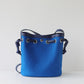 Blue bucket bag with drawstring on a light gray background