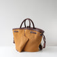Brown handbag with a matching pouch on a light gray background