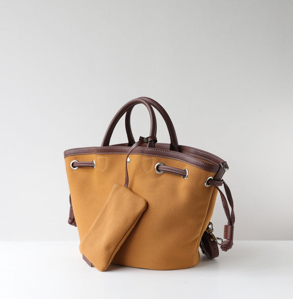 Brown handbag with a matching pouch on a light gray background