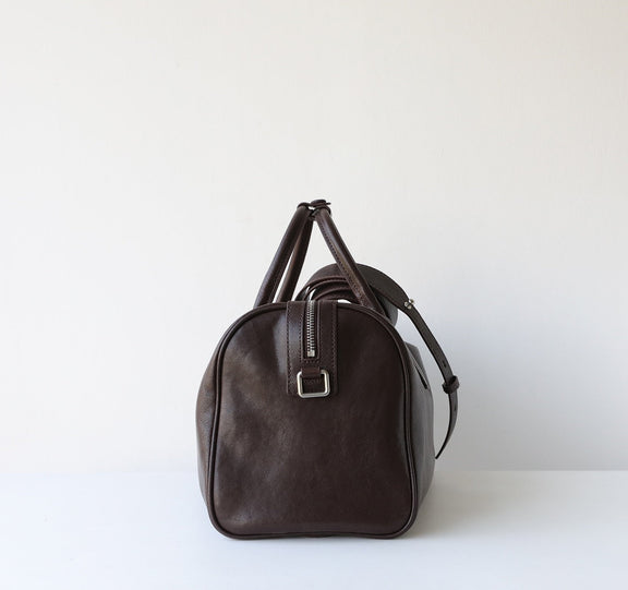Brown leather duffel bag on a white background