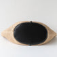 Woven clutch with black interior on a white background