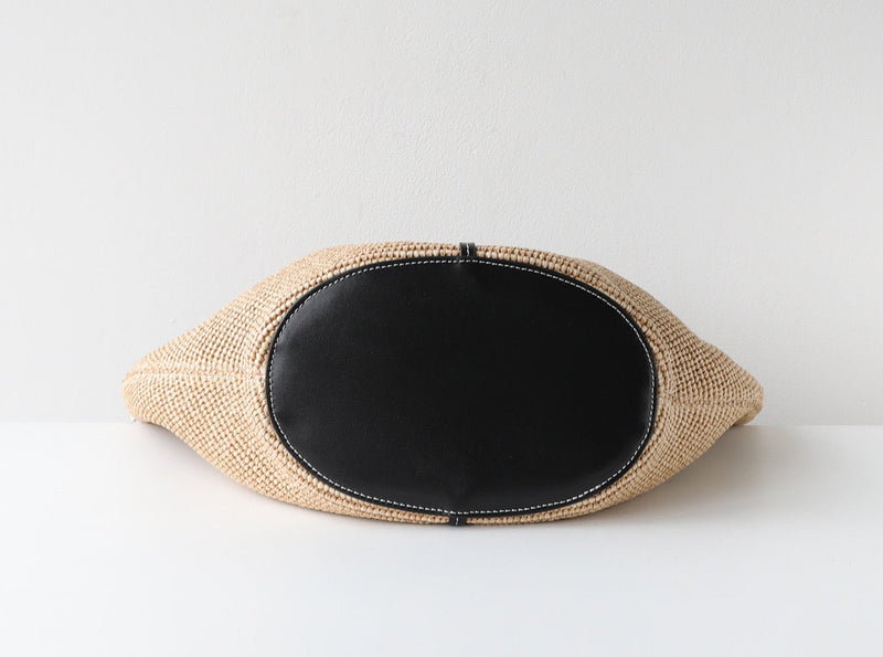 Woven clutch with black interior on a white background
