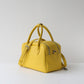 Yellow handbag on a light gray background