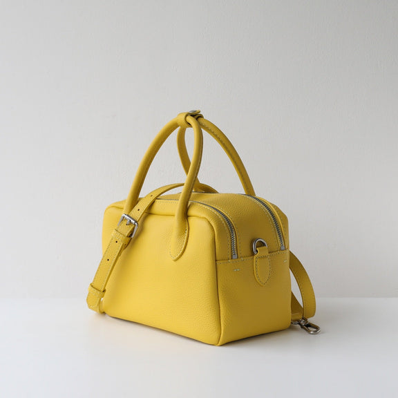 Yellow handbag on a light gray background