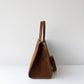 Brown leather handbag on a white background