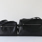 Two black leather bags on a white background
