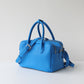 Blue handbag on a light gray background