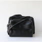Black leather bag on a white background