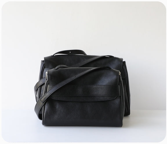 Black leather bag on a white background