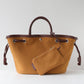 Brown leather handbag with matching pouch on a light gray background