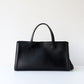 Black handbag on a white background