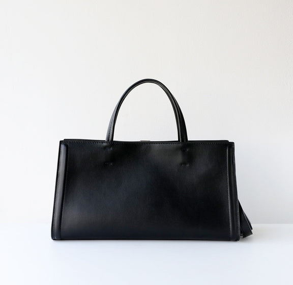Black handbag on a white background
