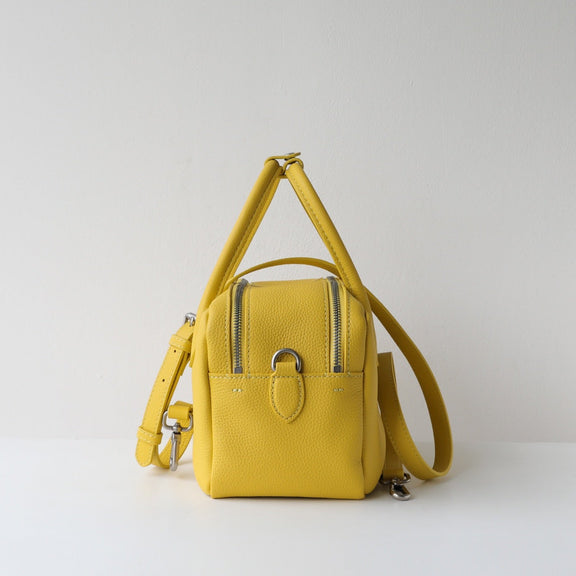 Yellow backpack on a light gray background