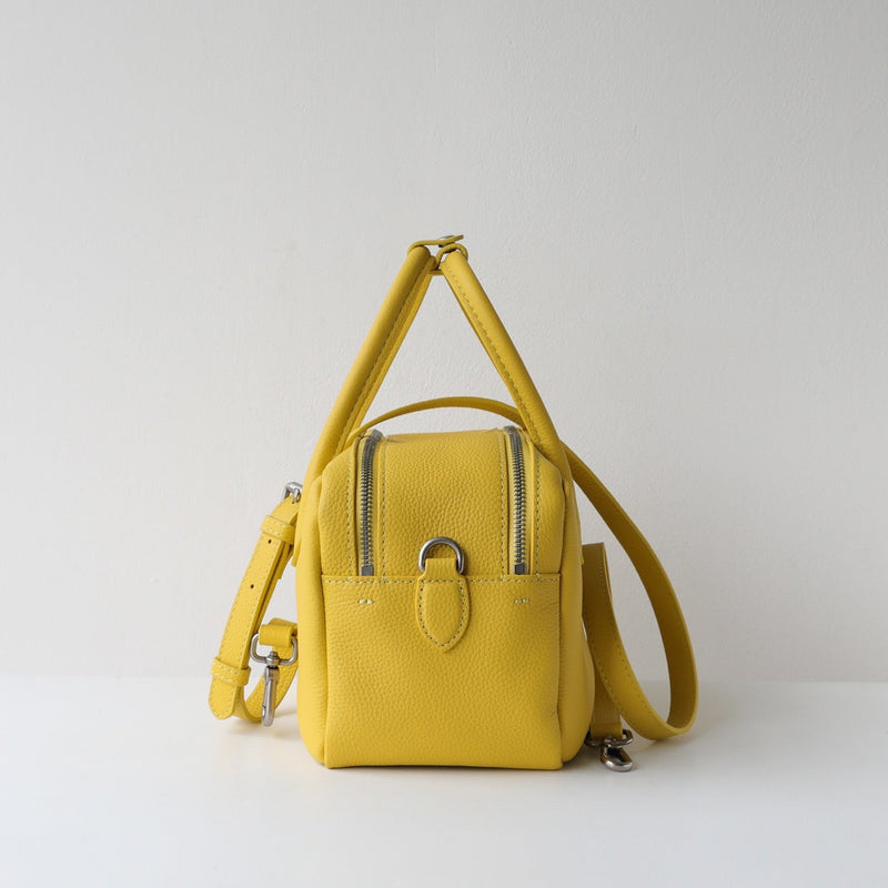 Yellow backpack on a light gray background