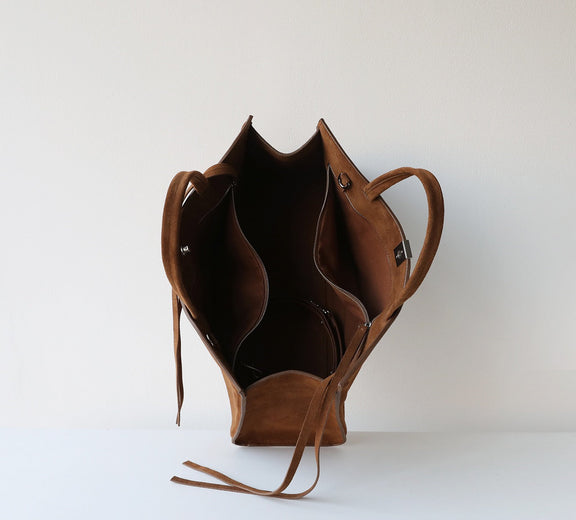 Brown leather bag on a white background