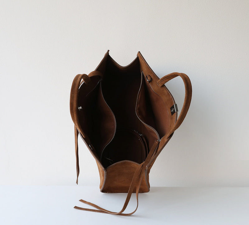 Brown leather bag on a white background