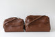 Two brown leather bags on a light gray background