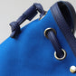 Blue bag with leather straps on a gray background