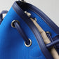 Blue handbag with drawstring closure on a light gray background