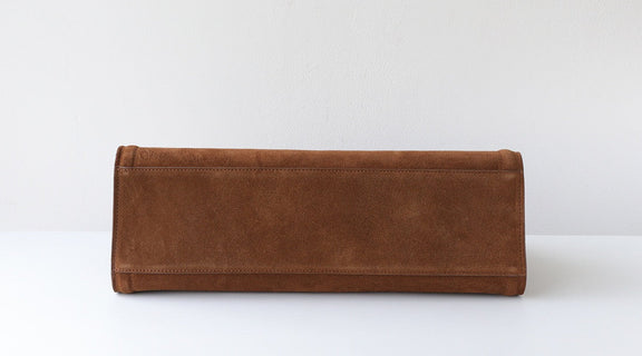 Brown leather clutch bag on a white background