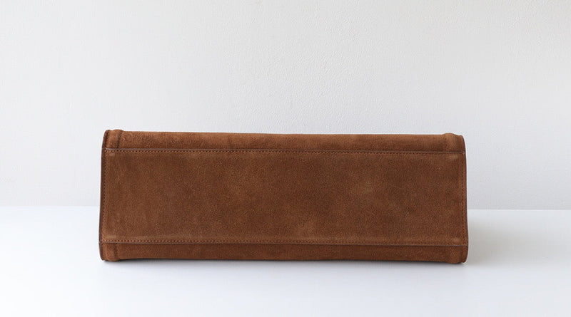 Brown leather clutch bag on a white background