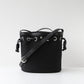Black bucket bag with a strap on a white background