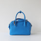 Blue handbag on a light gray background