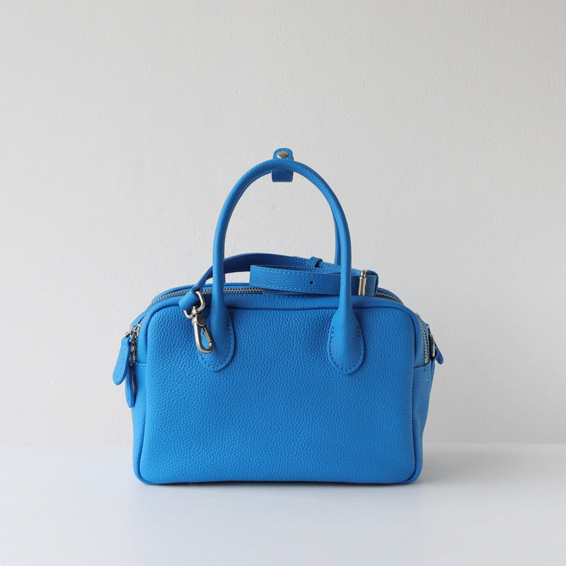 Blue handbag on a light gray background