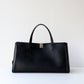 Black leather handbag on a white background