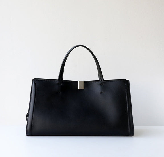 Black leather handbag on a white background