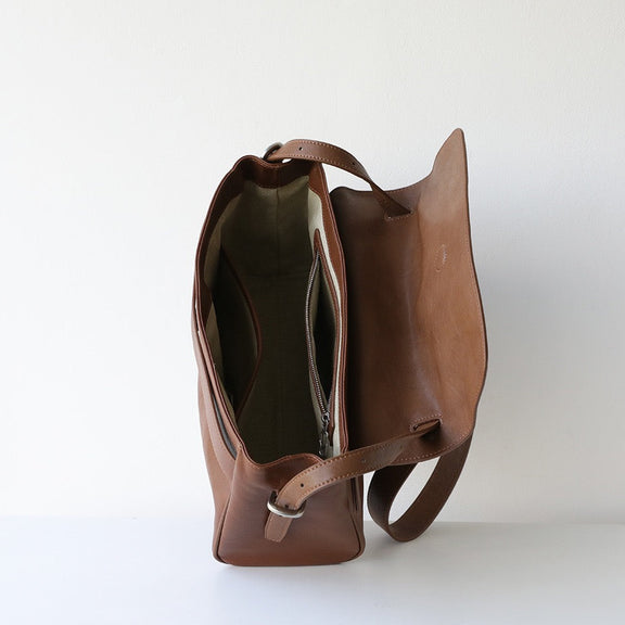 Brown leather handbag on a white background