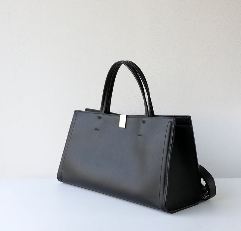 Black handbag on a light gray background