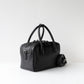 Black handbag on a white background