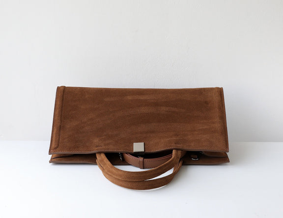 Brown leather nubuck bag on a white background