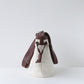 Small bag with a brown strap on a light gray background