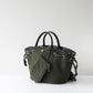 Green handbag with black handles on a white background