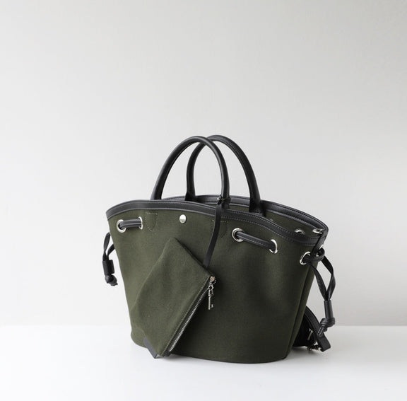 Green handbag with black handles on a white background