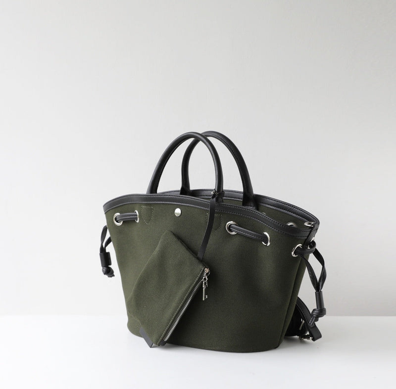 Green handbag with black handles on a white background