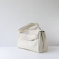 White handbag on a light gray background