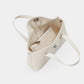 Beige handbag with a strap on a light gray background