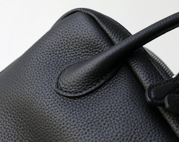 Close-up of a black leather glove with a textured surface