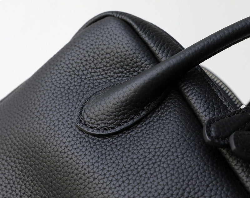 Close-up of a black leather glove with a textured surface