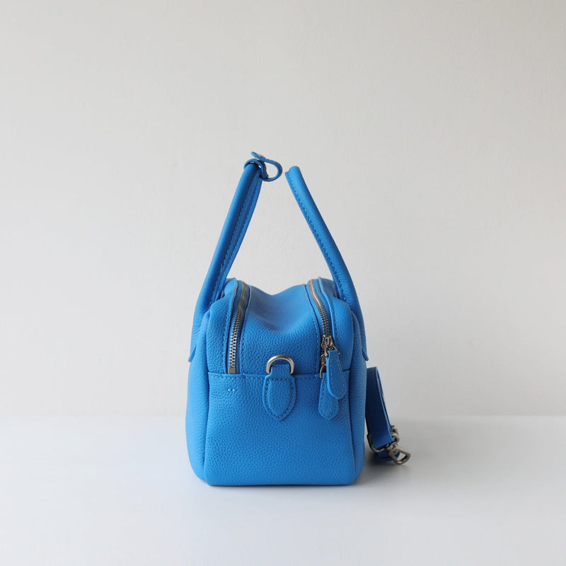 Blue handbag on a light gray background