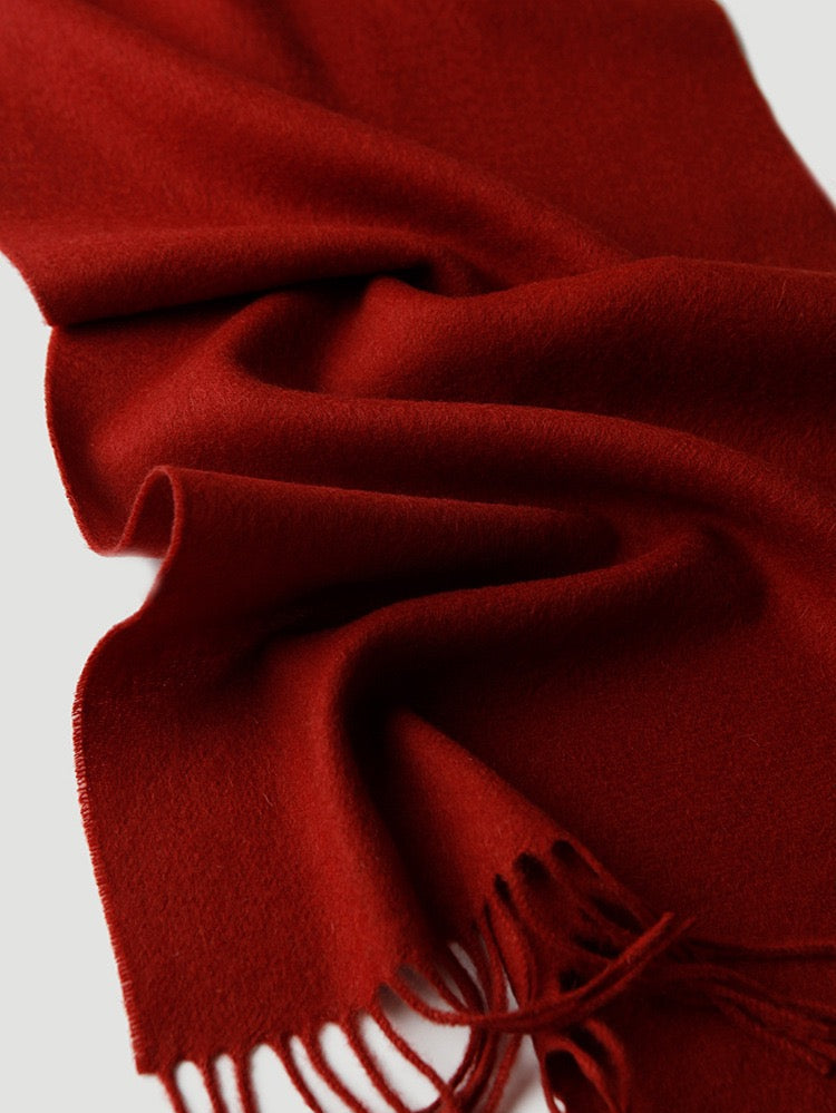 Red wool scarf with fringes on a white background


