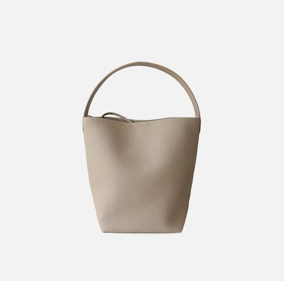 Beige handbag with a handle on a light gray background