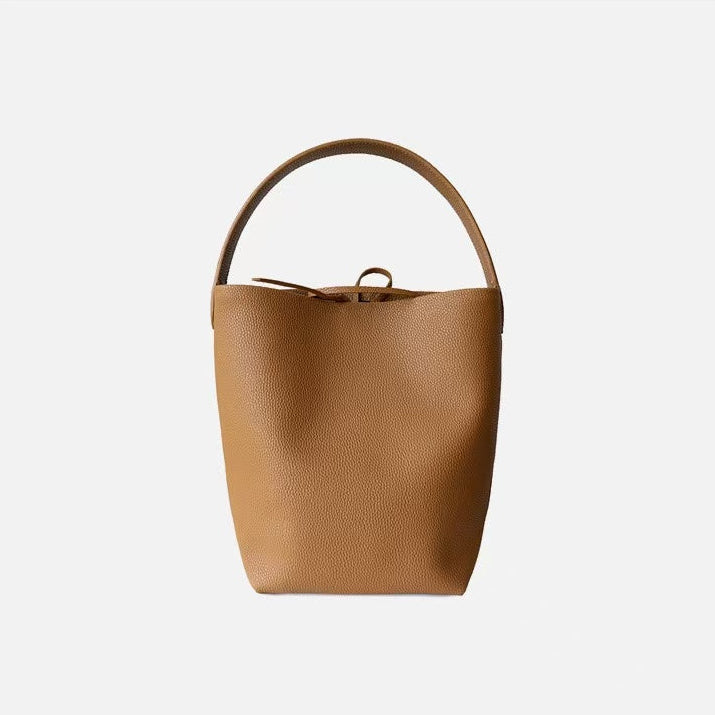 Brown leather bucket bag on a white background